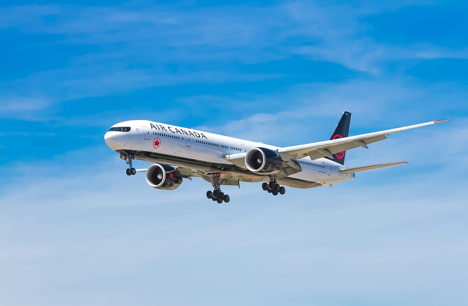 Commercial airplane flying in a clear blue sky